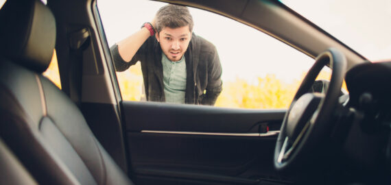 man forgot the key inside of his car.Transportation, crime and ownership concept